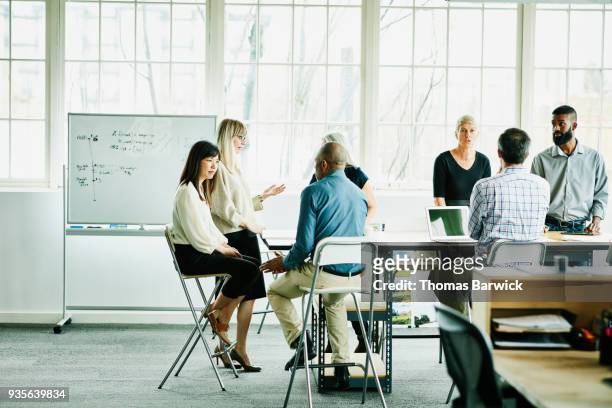engineers and designers in team meeting in design office conference room - group people thinking stock pictures, royalty-free photos & images