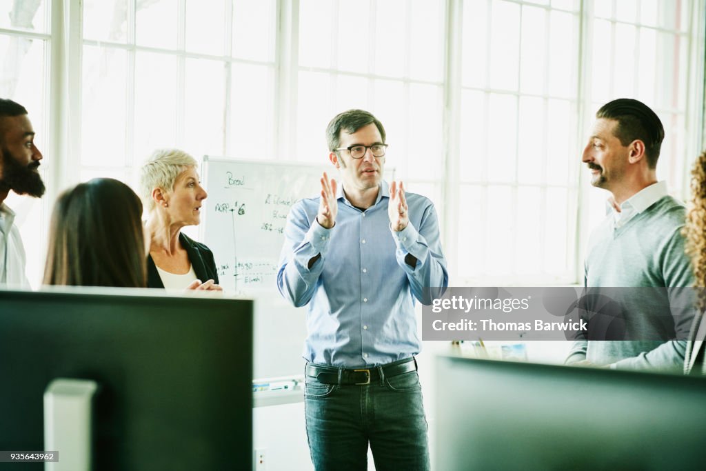 Businessman leading team meeting in high tech start up office