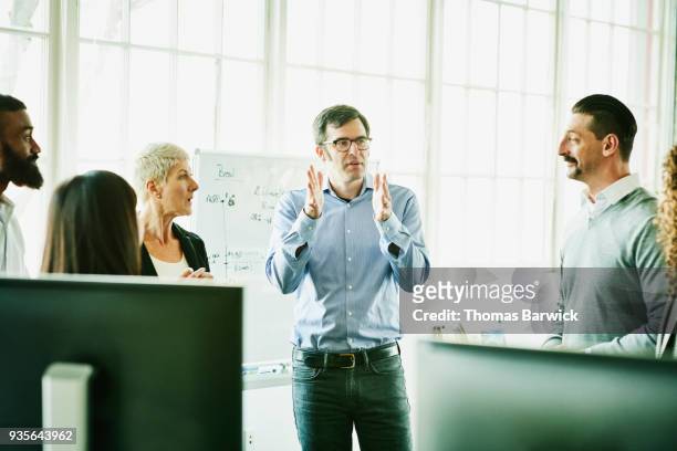 businessman leading team meeting in high tech start up office - financial guidance stock pictures, royalty-free photos & images