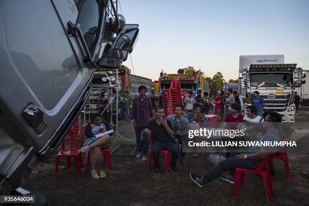 This photograph taken on December 23, 2017 shows truck drivers and enthusiasts gathering around custom-painted trucks at a fancy truck party in the...