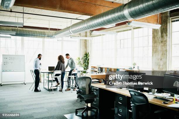 architects having planning meeting at conference table in design studio - bookstand stock pictures, royalty-free photos & images