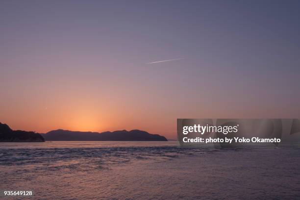 sunset from naruto strait seen from awajishima - sunset with jet contrails stock pictures, royalty-free photos & images