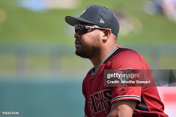 Yasmany Tomas of the Arizona Diamondbacks reacts while warming up for the spring training game against the Los Angeles Angels at Salt River Fields at...