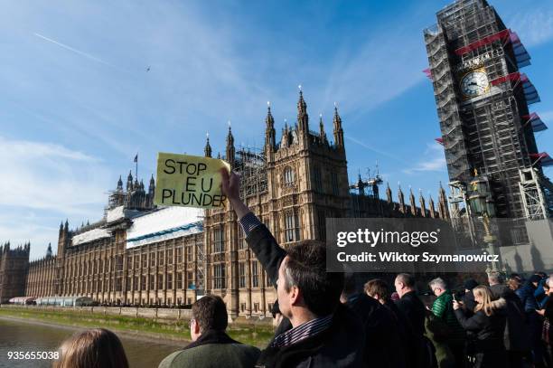 Pro-Brexit supporter holds anti-EU placard on Westminster Bridge as Fishing for Leave campaigners stage a protest on the river Thames against the...