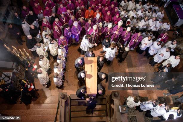 Pallbearers carry the coffin of Cardinal Karl Lehmann into bishop tomb in the Mainzer Dom cathedral during the funeral service for Lehmann on March...