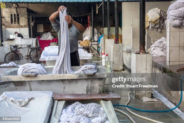 Dhobi wallahs or washermen, launder clothes and linen at the Devi Prasad Sadan Dhobi Ghat in New Delhi, India. The ghat is home to around 64...