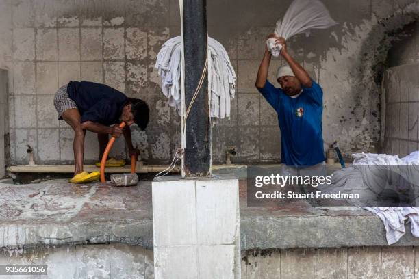 Dhobi wallahs or washermen, launder clothes and linen at the Devi Prasad Sadan Dhobi Ghat in New Delhi, India. The ghat is home to around 64...
