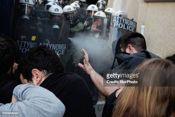 Protesters clash with police as they try to stop auctions of foreclosed properties at a notary's office in central Athens on March 21, 2018. Auctions...