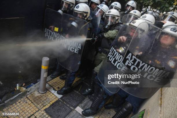 Police use tear gas as protesters opposing properties auctions protesters scuffled with riot police outside a notary office in Athens, Greece, on...