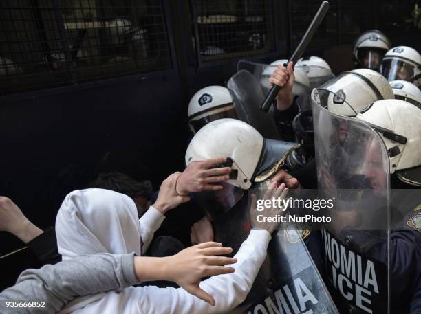 Protesters scuffled with riot police outside a notary office in Athens, Greece, on Wednesday 21 of March, where electronic auctions of foreclosed...