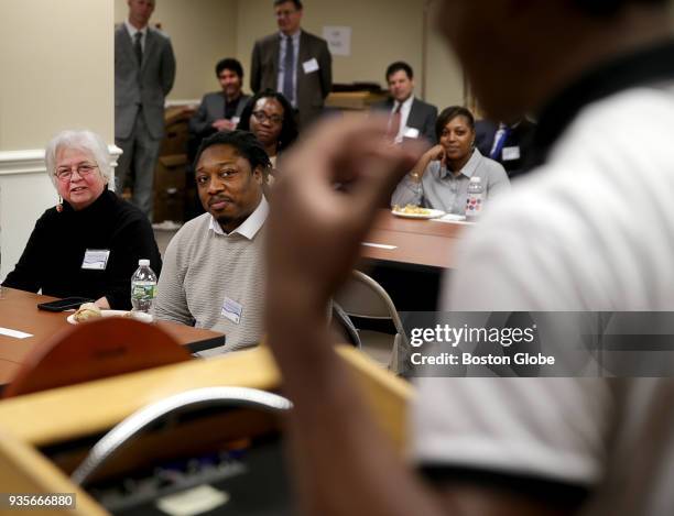 Attendees Nikki Flionis, left, and Jummane Kendrick, right, listen to a young man who is going through the Juvenile Alternative Resolution program...