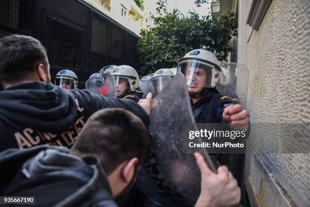 Protesters scuffled with riot police outside a notary office in Athens, Greece, on Wednesday 21 of March, where electronic auctions of foreclosed...
