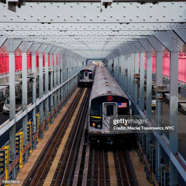 j subway train crossing williamsburg bridge. - williamsburg new york city stock pictures, royalty-free photos & images