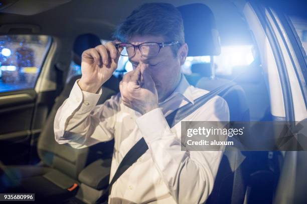 tired driver inside car at night - glasses rubbing eyes stock pictures, royalty-free photos & images