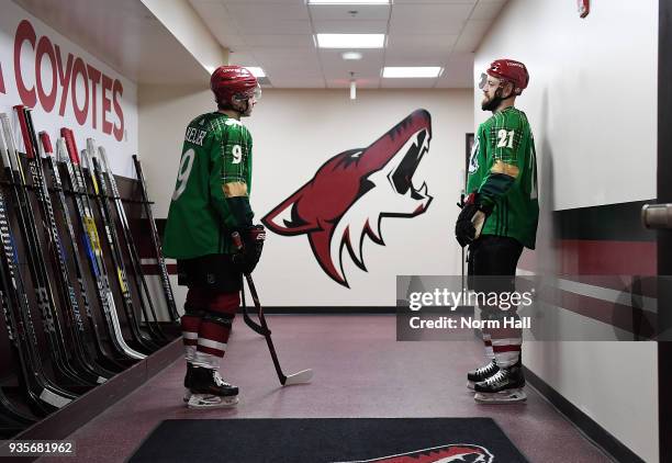 Clayton Keller and Derek Stepan of the Arizona Coyotes wear special green warm up jerseys in recognition of St. Patricks Day prior to a game against...