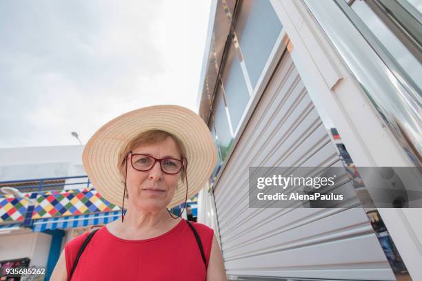 senior woman with sun hat portrait - playa de las americas stock pictures, royalty-free photos & images