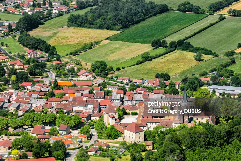 Aerial view of french village of Ambronay in Ain countryside with famous abbey and church in summer season