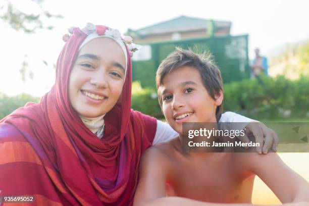 Muslim teenage girl with her brother on vacation