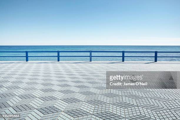 empty coastal boardwalk with geometric tile pattern, alicante, spain - alicante street stock pictures, royalty-free photos & images