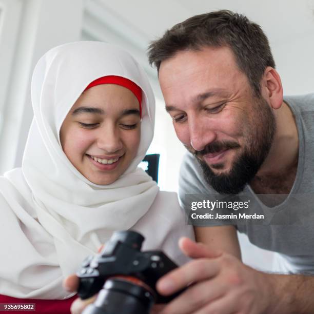 muslim father and daughter laughing - interracial wife photos stock-fotos und bilder