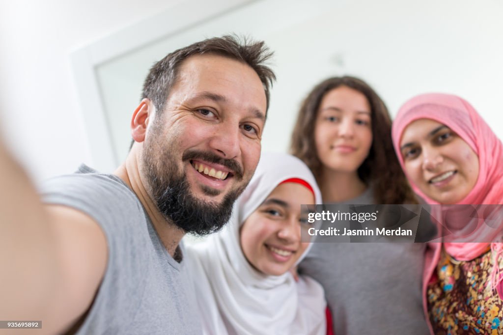 Happy Muslim family taking selfie