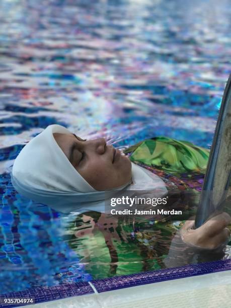 arabian woman in pool - burkini bildbanksfoton och bilder