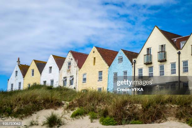 row of houses and at braye beach, alderney, guernsey, channel islands - channel islands england stock pictures, royalty-free photos & images