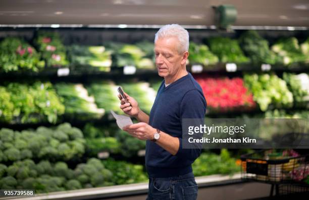 senior man goes grocery shopping. - shopping list stock pictures, royalty-free photos & images