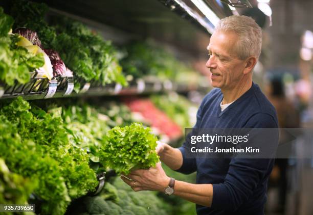 senior man goes grocery shopping. - lettuce fotografías e imágenes de stock