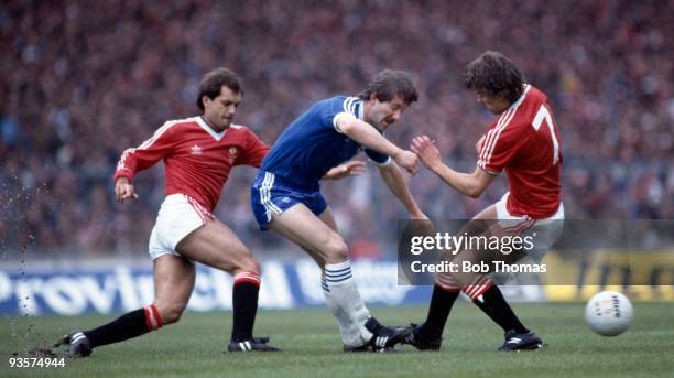 Jimmy Case of Brighton is sandwiched between Manchester United's Ray Wilkins and Bryan Robson during the FA Cup Final between Brighton and Manchester...
