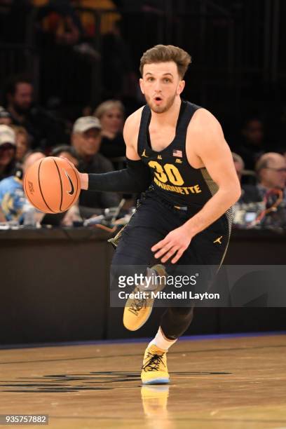 Andrew Rowsey of the Marquette Golden Eagles dribbles up court during the quarterfinal round the Big East Men's Basketball Tournament against the...