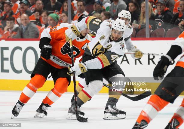 Pierre-Edouard Bellemare of the Vegas Golden skates the puck against Valtteri Filppula of the Philadelphia Flyers on March 12, 2018 at the Wells...