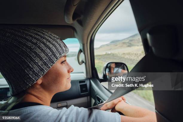 young woman sitting in car, looking at view out of car window, silverthorne, colorado, usa - passagerarsäte bildbanksfoton och bilder