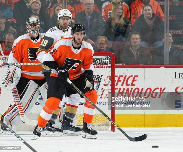 Brandon Manning and Petr Mrazek of the Philadelphia Flyers defend a scoring opportunity against Alex Tuch of the Vegas Golden Knights on March 12,...