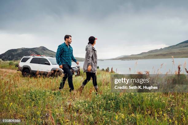 couple walking beside dillon reservoir, silverthorne, colorado, usa - full body car stock pictures, royalty-free photos & images