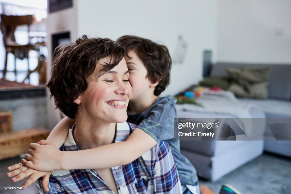 Mother and son at home, son hugging mother