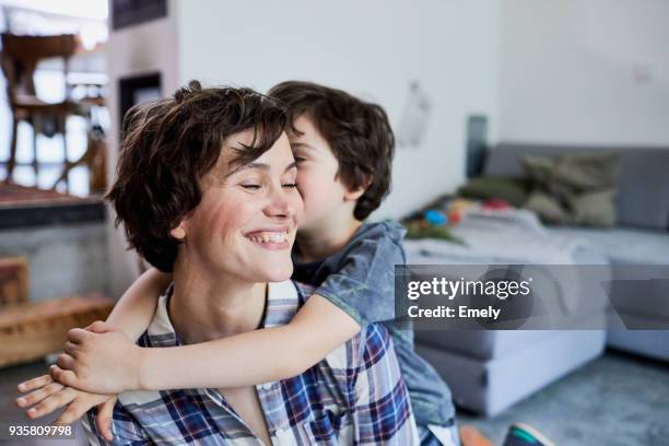 mother and son at home, son hugging mother - mutter kind stock-fotos und bilder