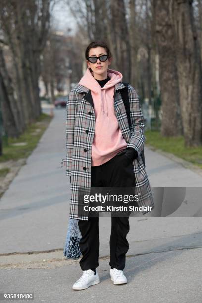 Fashion blogger for number-93 Sylvia Haghjoo wears Céline sunglasses, Burberry coat, Acne hooded sweater, Stella McCartney trousers and Adidas...
