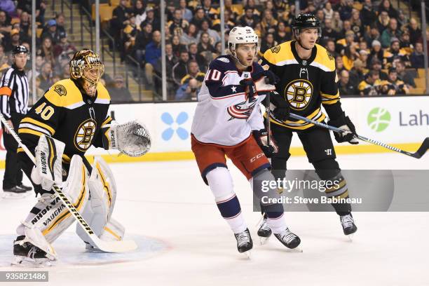 Tuukka Rask and Nick Holden of the Boston Bruins against Alexander Wennberg of the Columbus Blue Jackets at the TD Garden on March 19, 2018 in...