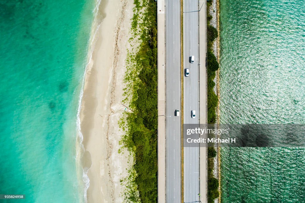 Aerial view of linear road and blue sea.