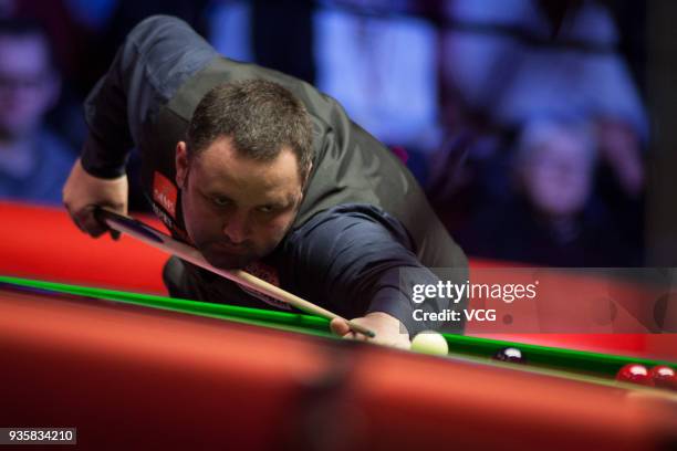 Stephen Maguire of Scotland plays a shot during his first round match against Judd Trump of England on day three of 2018 Ladbrokes Players...