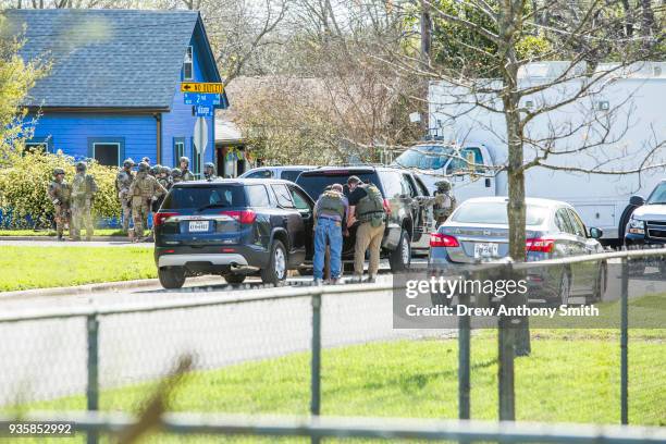 Police barricade the area surrounding the home of suspected Austin bomber Mark Anthony Conditt March 21, 2018 in Pflugerville, Texas. Conditt blew...