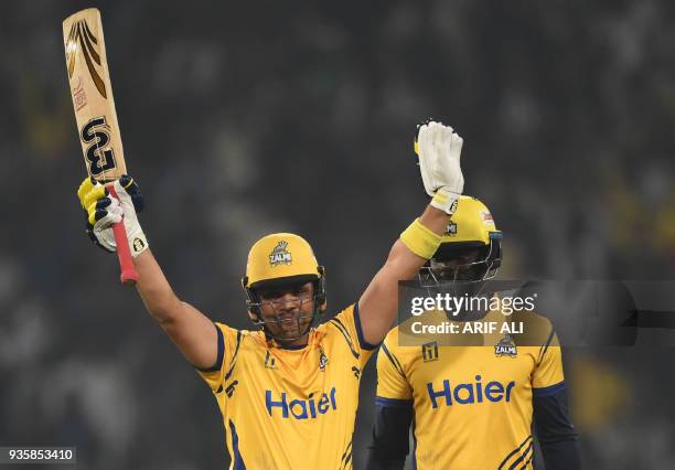 Kamran Akmal of Peshawar Zalmi celebrates after he scored a half century against Karachi King next to his teammate Andre Fletcher during the Twenty20...