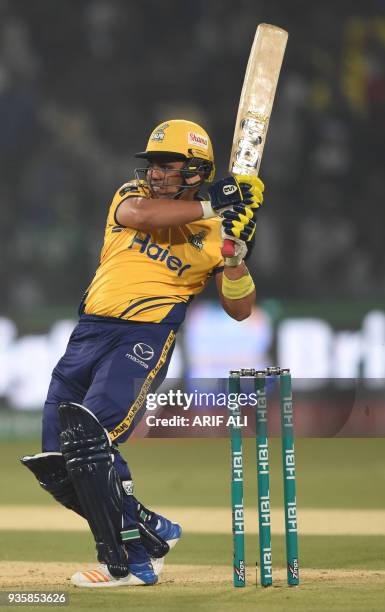 Cricketer Kamran Akmal of Peshawar Zalmi plays a shot during the Twenty20 cricket match of the Pakistan Super League between Peshawar Zalmi and...