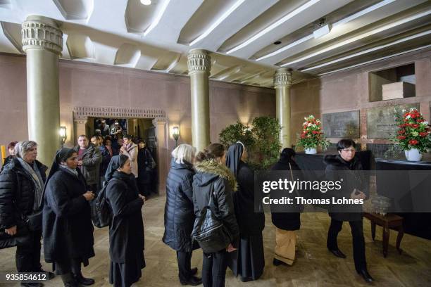People pay their respects to Cardinal Karl Lehmann in the bishop's tomb in the Mainzer Dom cathedral after the funeral service for Lehmann on March...