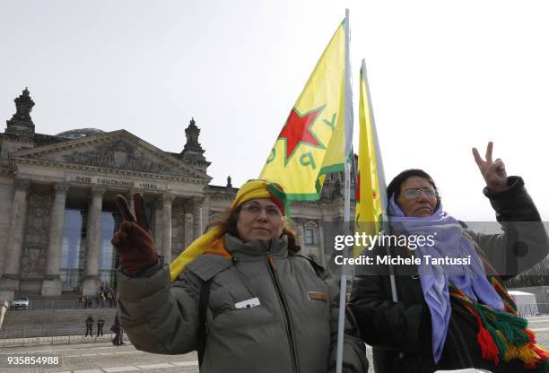 People bearing flags of the Kurdish YPG militia protest against the Turkish military intervention in Afrin province in Syria outside the Chancellery...