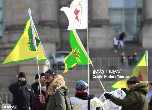 People bearing flags of the Kurdish YPG militia protest against the Turkish military intervention in Afrin province in Syria outside the Chancellery...