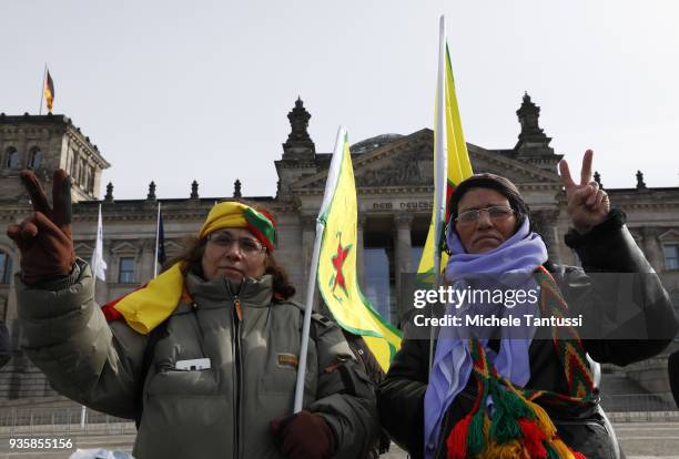 People bearing flags of the Kurdish YPG militia protest against the Turkish military intervention in Afrin province in Syria outside the Chancellery...