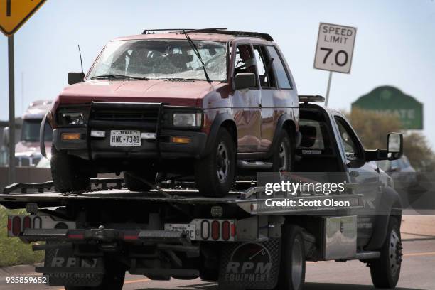 The vehicle that the Austin package bomber, Mark Anthony Conditt, was driving when he blew himself up is towed from the crime scene along Interstate...