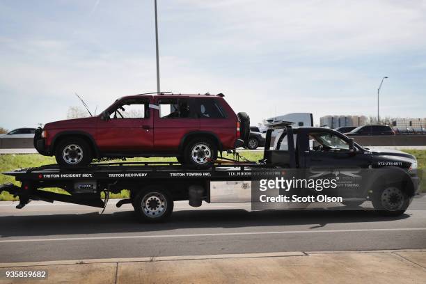 The vehicle that the Austin package bomber, Mark Anthony Conditt, was driving when he blew himself up is towed from the crime scene along Interstate...